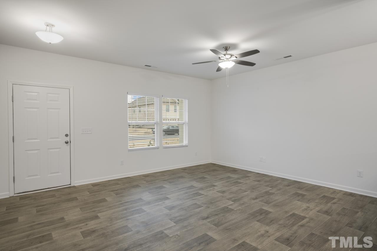 309 Connect Drive Wendell, NC 27591 - Photo 6 of 29 wooden floor in an empty room with a window