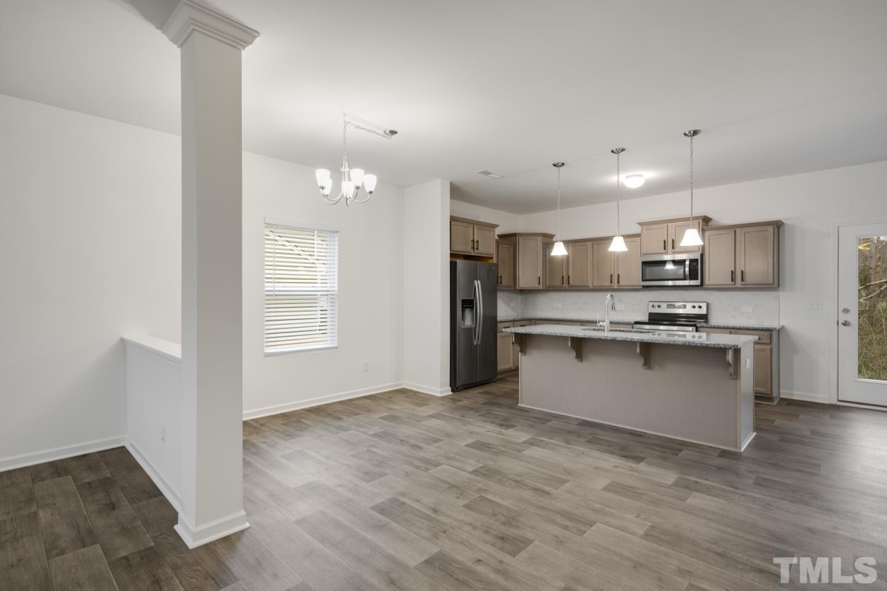 309 Connect Drive Wendell, NC 27591 - Photo 8 of 29 a view of kitchen with granite countertop refrigerator oven sink and white cabinets