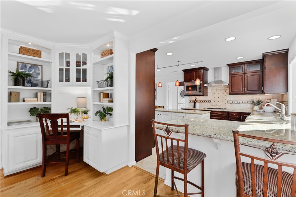 190 Lilac Lane Brea, CA 92823 - Photo 36 of 72 a kitchen with stainless steel appliances kitchen island granite countertop a refrigerator a stove a sink a dining table and chairs with wooden floor