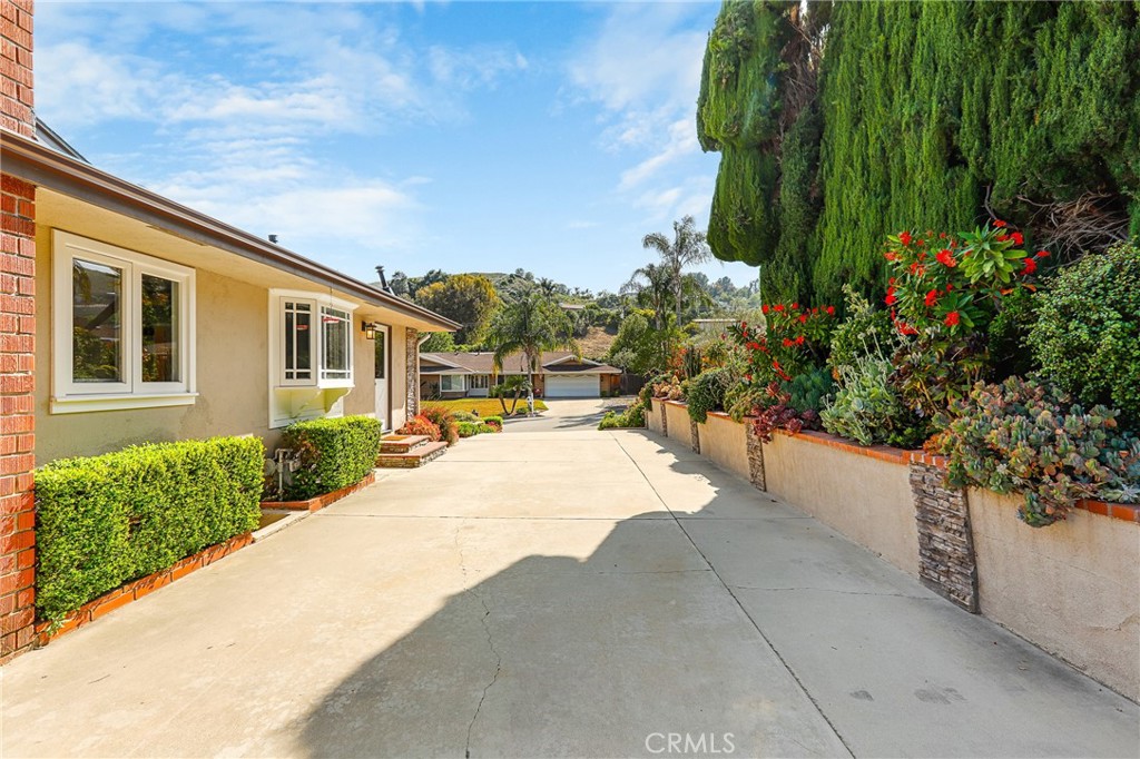 190 Lilac Lane Brea, CA 92823 - Photo 39 of 72 a house with a yard and plant in front of it