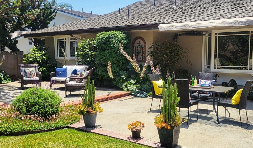 190 Lilac Lane Brea, CA 92823 - Photo 42 of 72 a view of a patio with table and chairs potted plants and a large tree