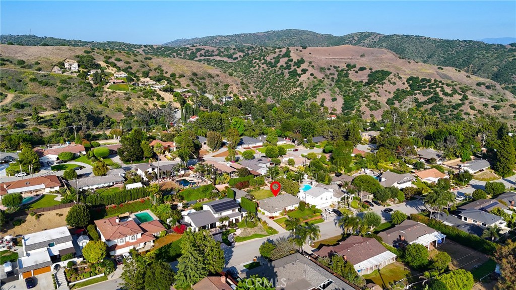 190 Lilac Lane Brea, CA 92823 - Photo 55 of 72 an aerial view of a houses with a lush green hillside