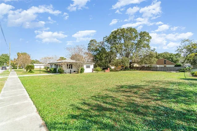 a front view of a house with yard and green space