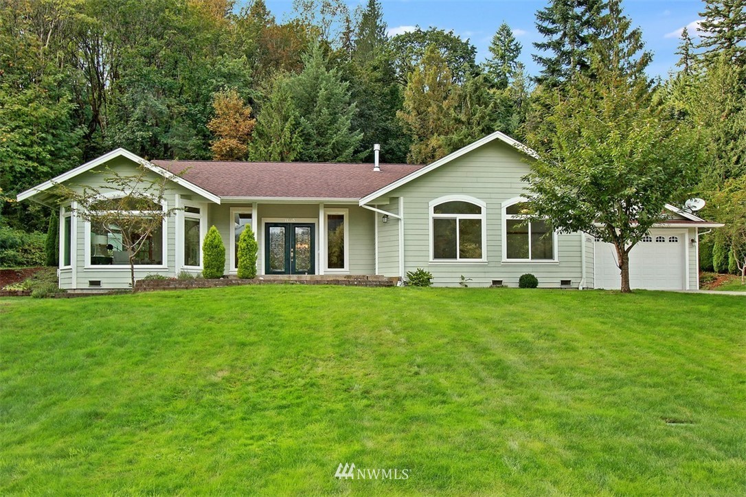 11225 Renton Issaquah Road Southeast Issaquah, WA 98027 - Photo 1 of 21 a front view of a house with a garden