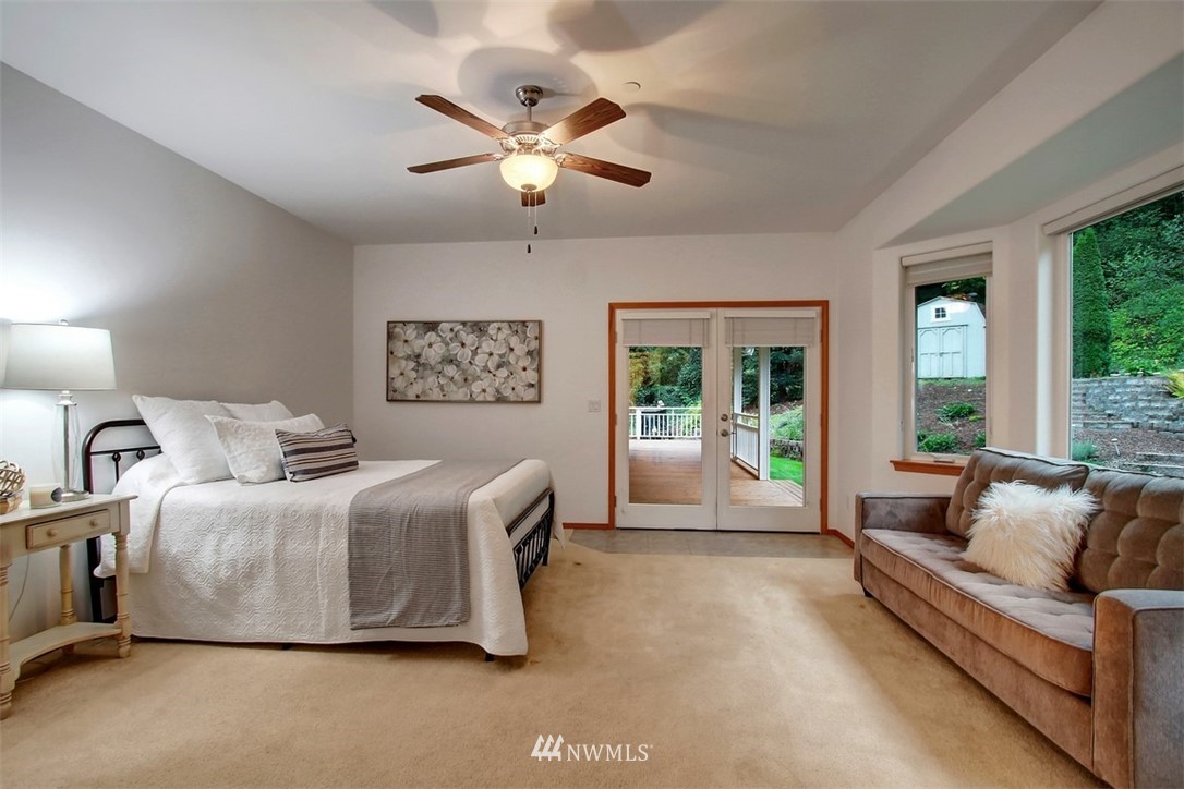 11225 Renton Issaquah Road Southeast Issaquah, WA 98027 - Photo 12 of 21 a spacious bedroom with a bed and glass walk in closet