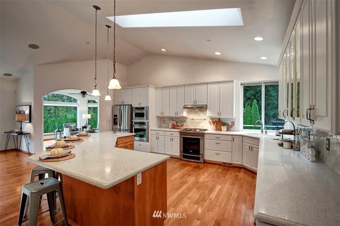 11225 Renton Issaquah Road Southeast Issaquah, WA 98027 - Photo 5 of 21 a large kitchen with a large window and stainless steel appliances