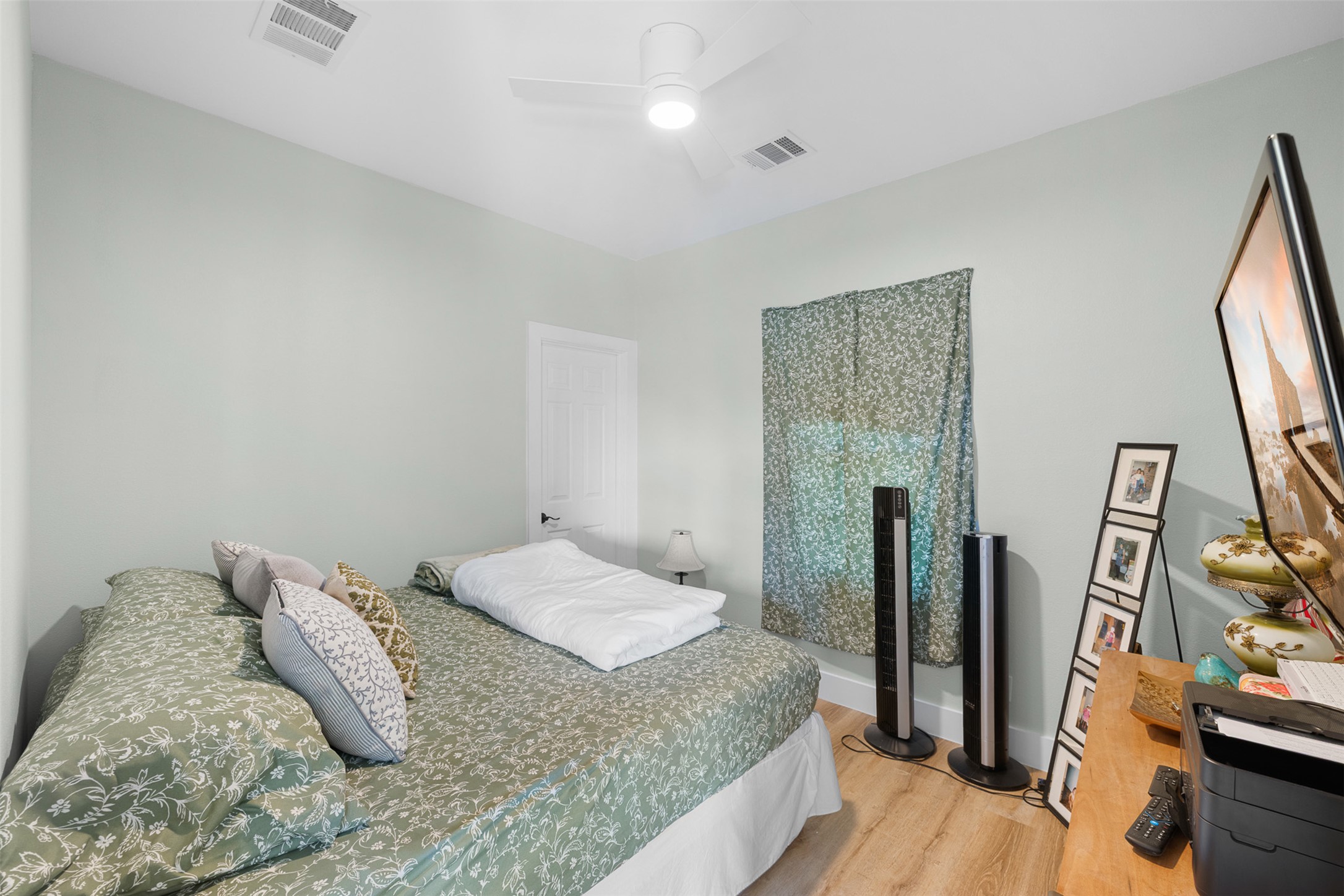 1759 Gotier Trace Road Paige, TX 78659 - Photo 17 of 40 a bedroom with a bed and a flat tv screen on the dresser