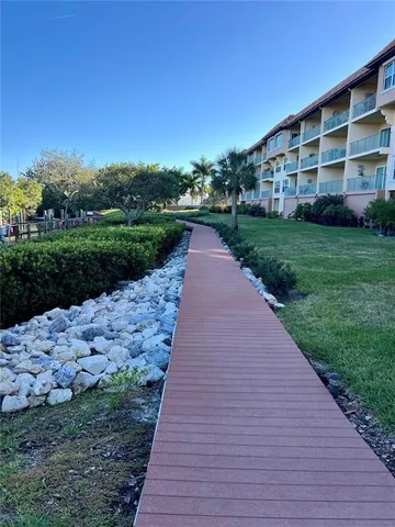 a bathroom with a granite countertop shower sink and mirror
