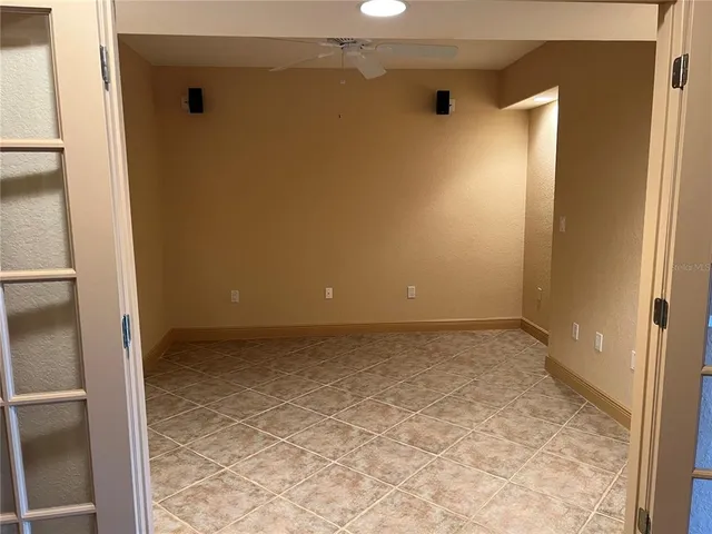 a row of palm trees in front of a house