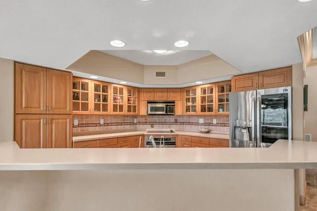 a kitchen with stainless steel appliances granite countertop a sink and stove top oven