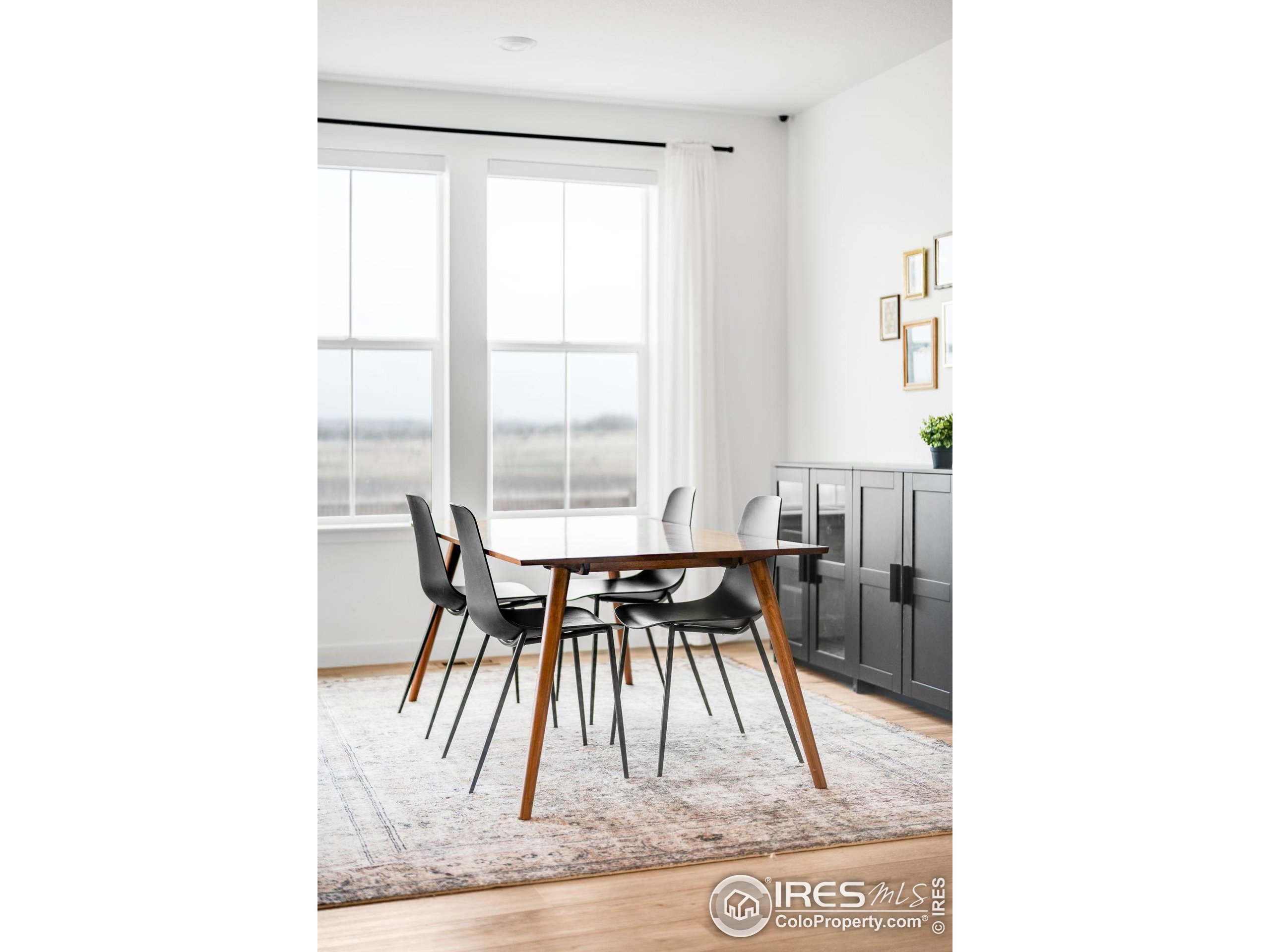 840 Clover Loop Lafayette, CO 80026 - Photo 14 of 39 a dining room with a table and chairs