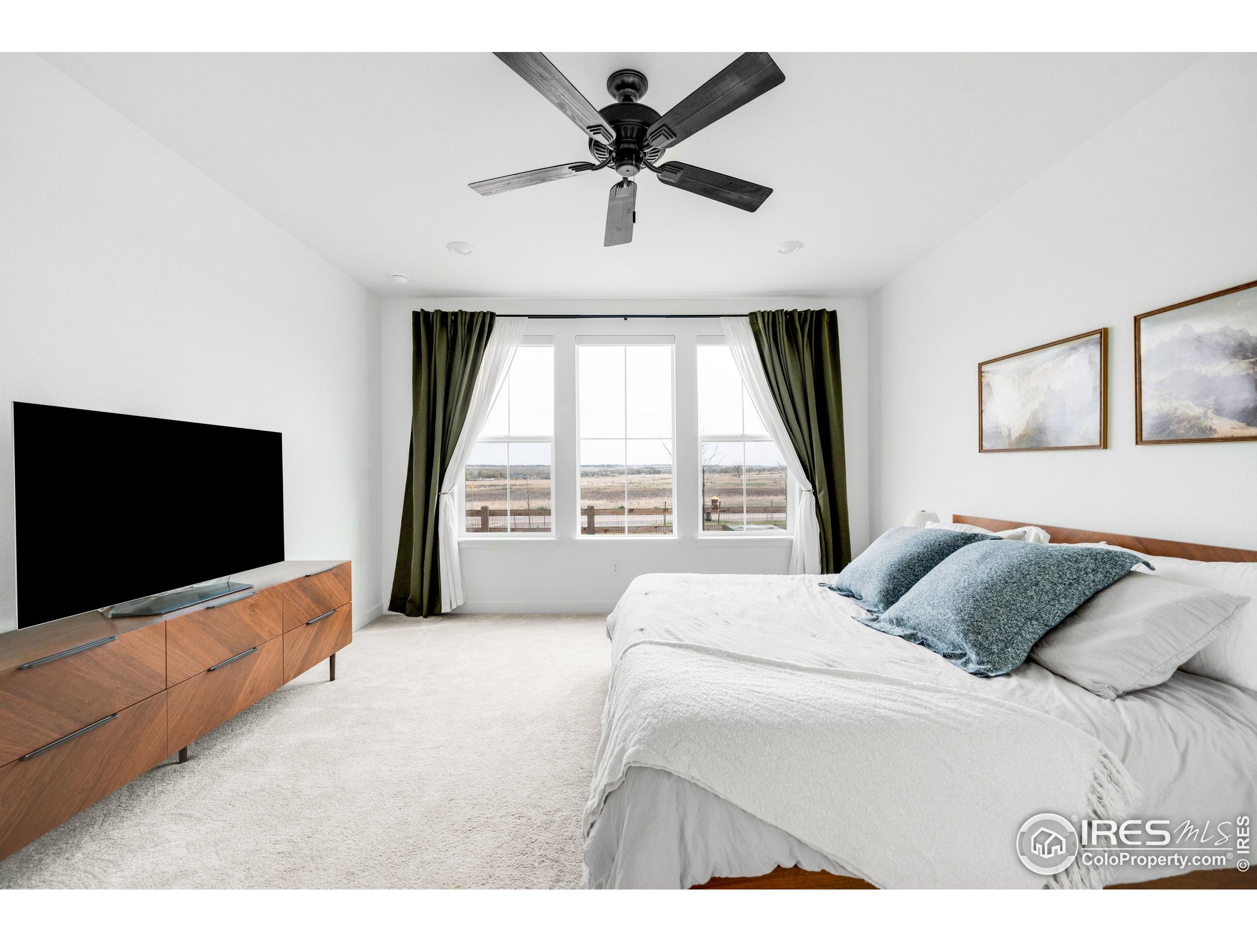 840 Clover Loop Lafayette, CO 80026 - Photo 17 of 39 a bedroom with a bed and a flat screen tv