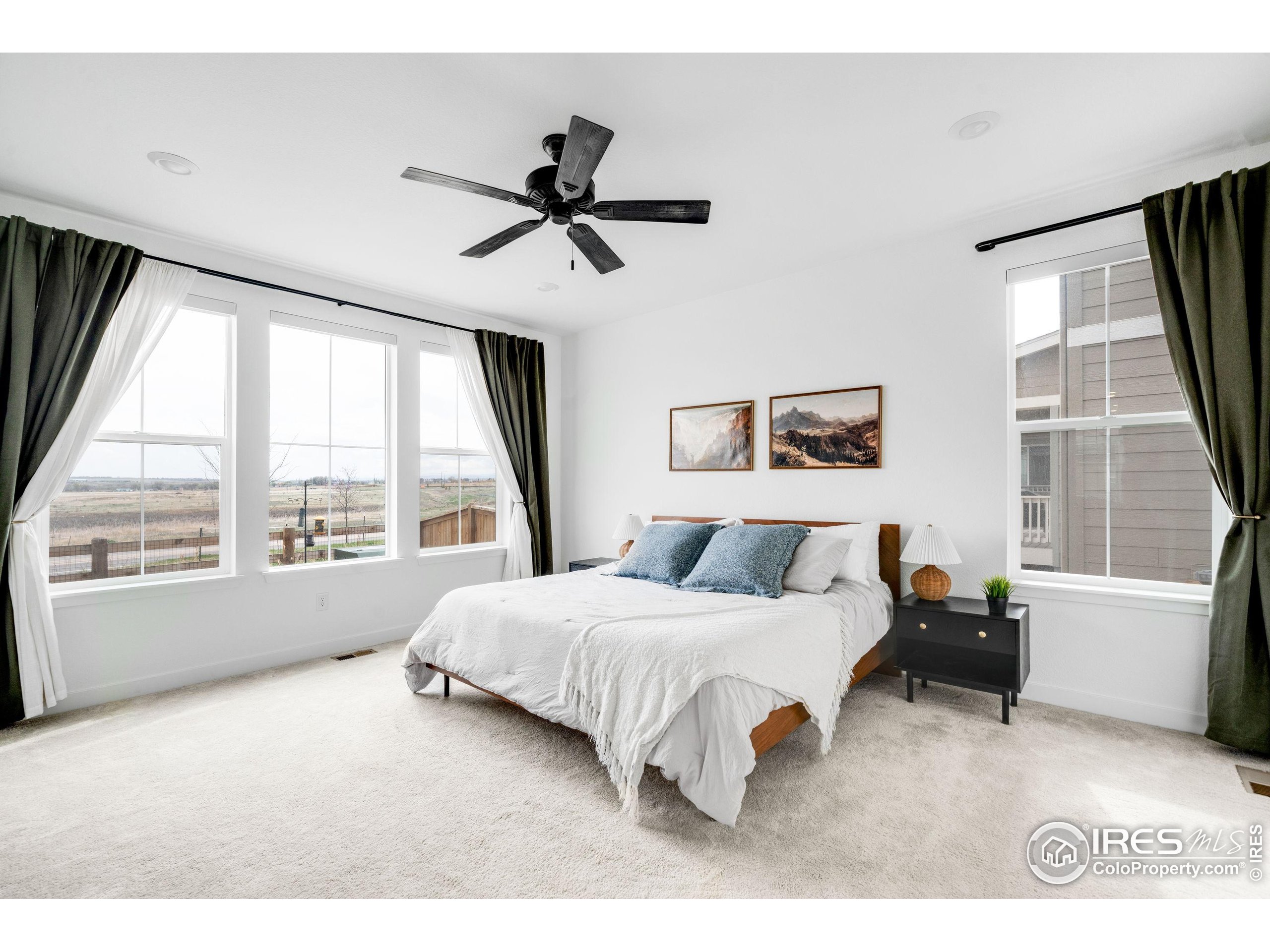 840 Clover Loop Lafayette, CO 80026 - Photo 18 of 39 a bedroom with a bed and a large window