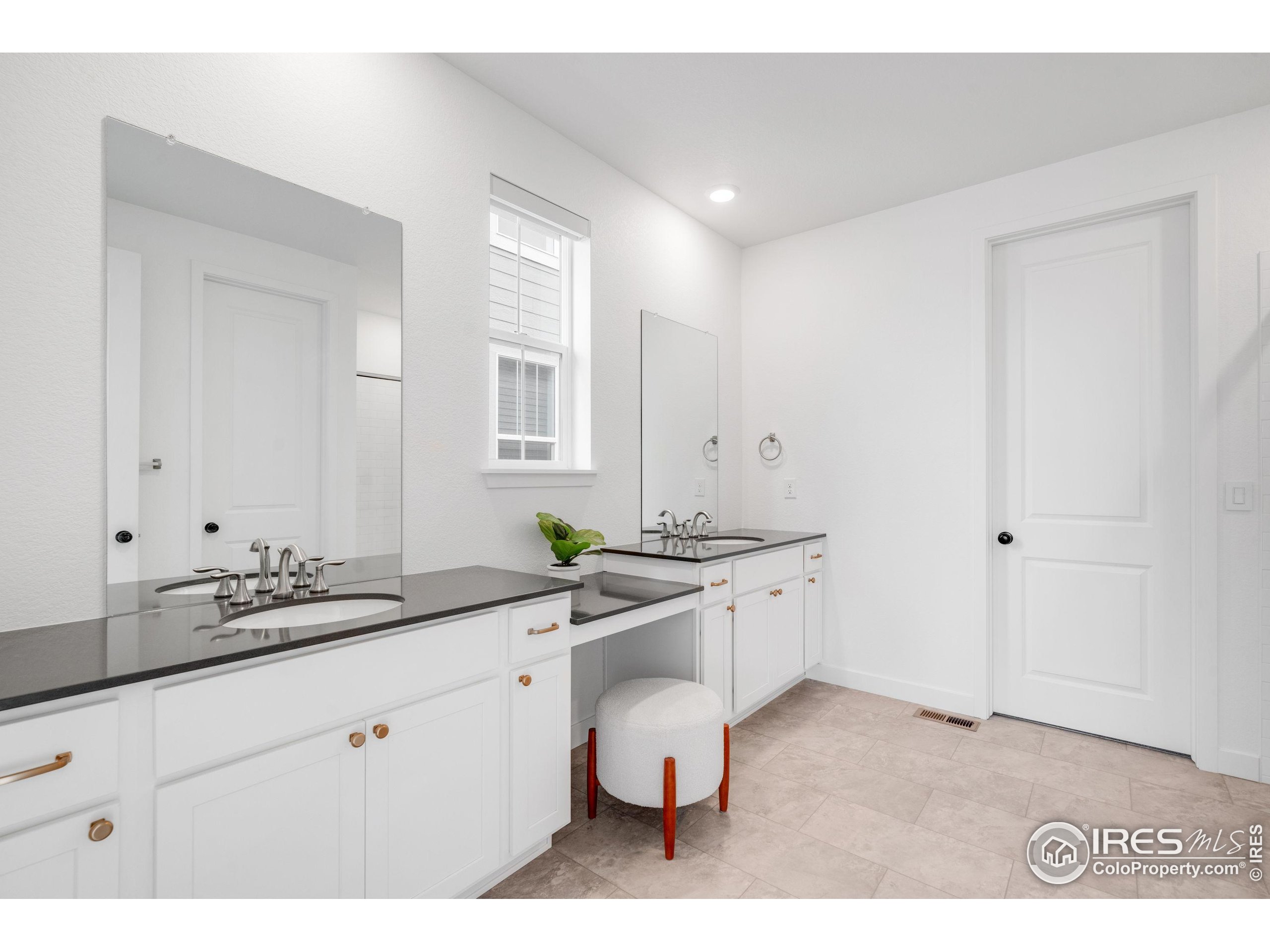 840 Clover Loop Lafayette, CO 80026 - Photo 23 of 39 a spacious bathroom with a sink and a mirror