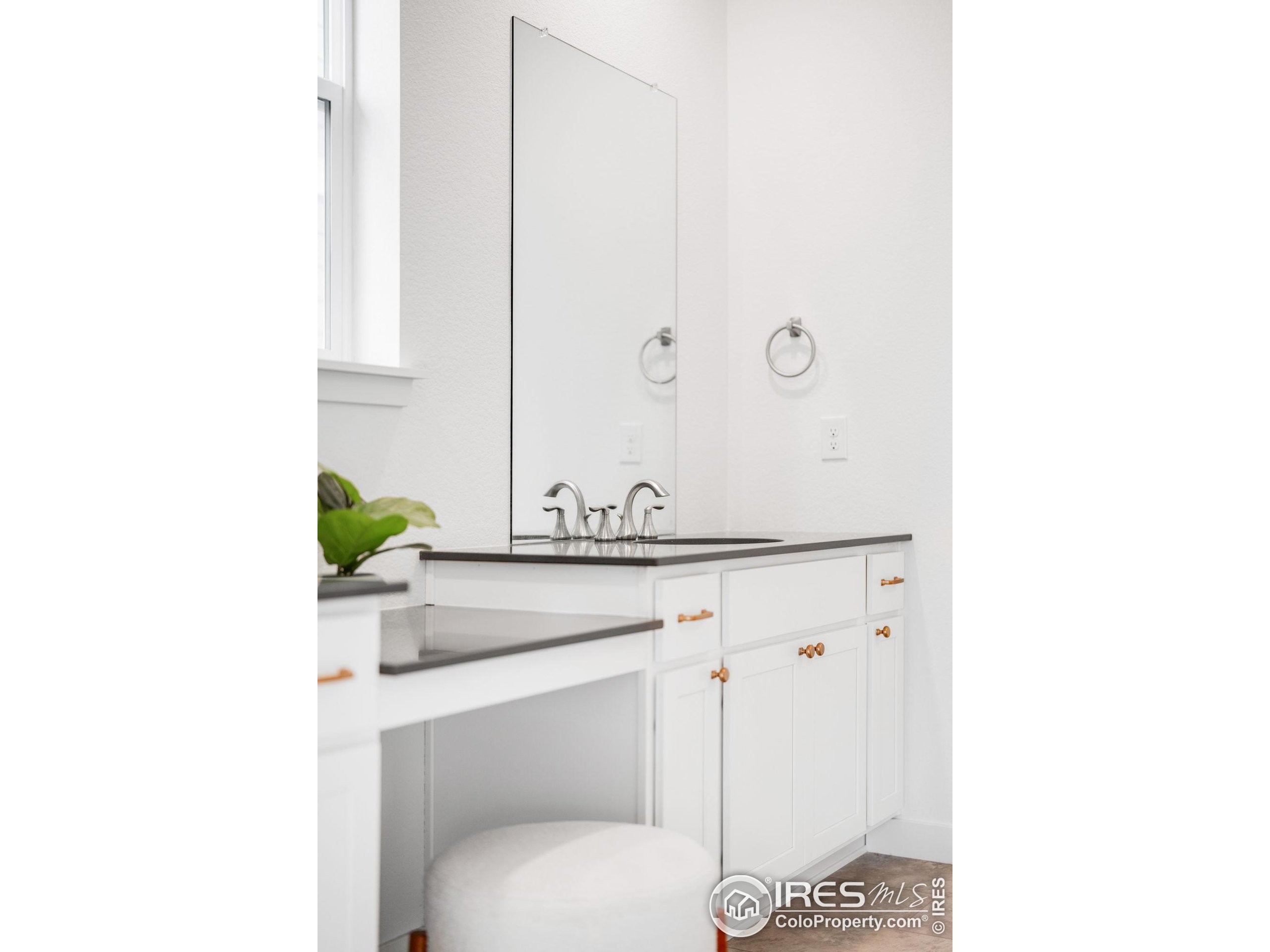 840 Clover Loop Lafayette, CO 80026 - Photo 24 of 39 a bathroom with a toilet a sink and mirror