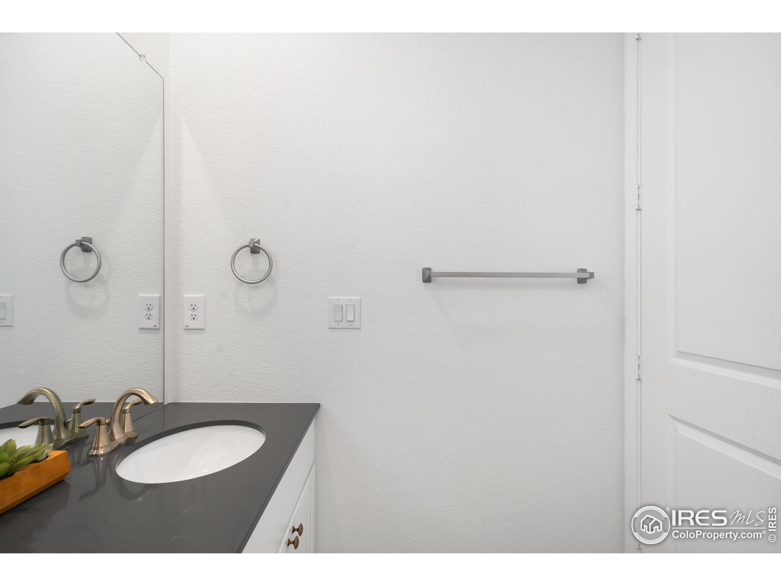 840 Clover Loop Lafayette, CO 80026 - Photo 31 of 39 a bathroom with a sink vanity mirror and toilet