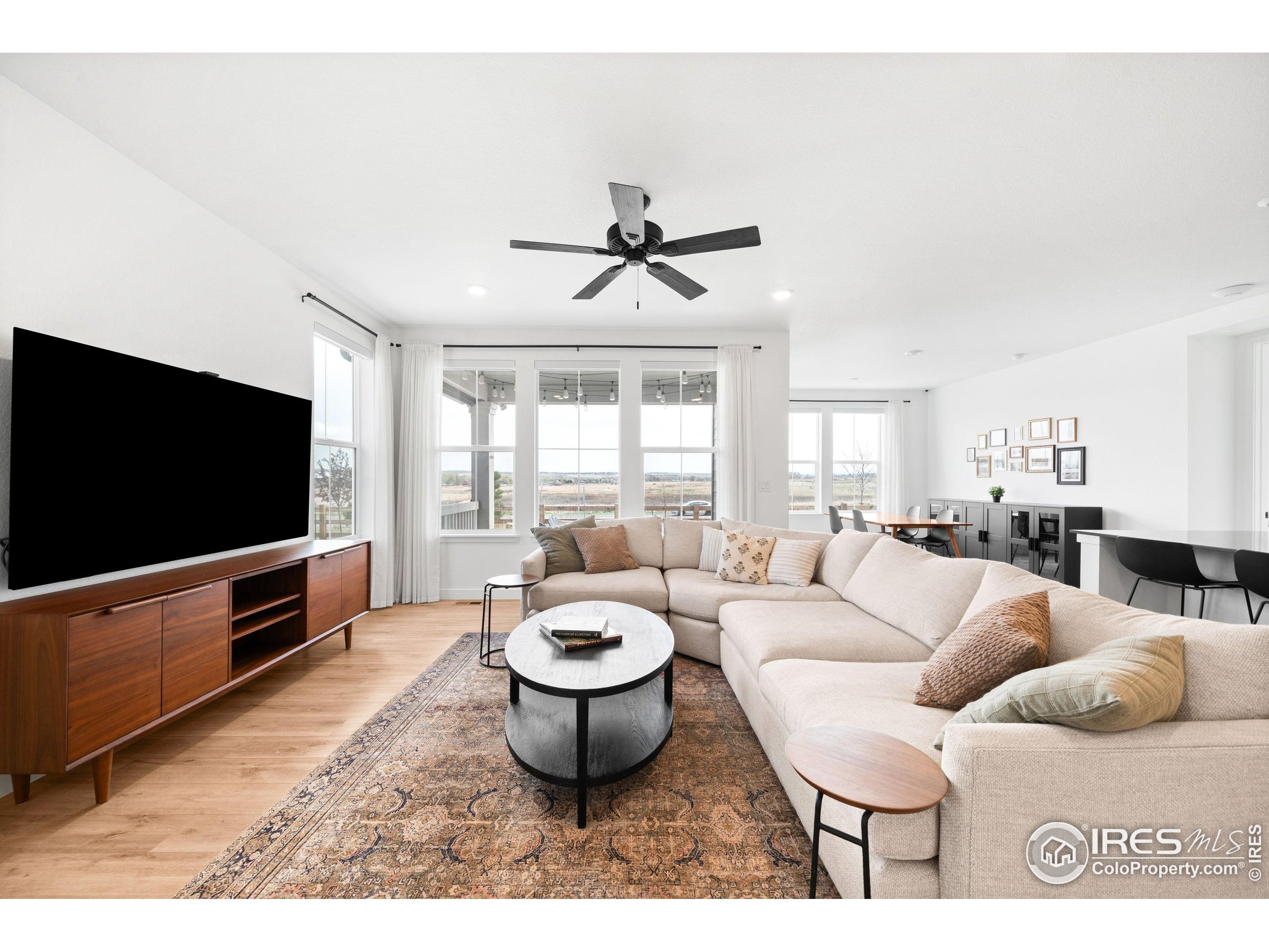 840 Clover Loop Lafayette, CO 80026 - Photo 4 of 39 a living room with furniture a flat screen tv and a window