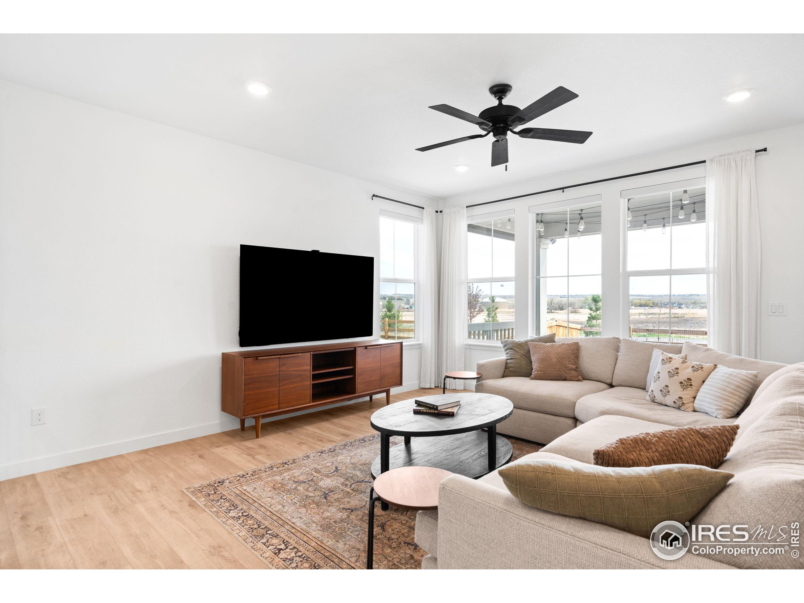 840 Clover Loop Lafayette, CO 80026 - Photo 8 of 39 a living room with furniture and a flat screen tv