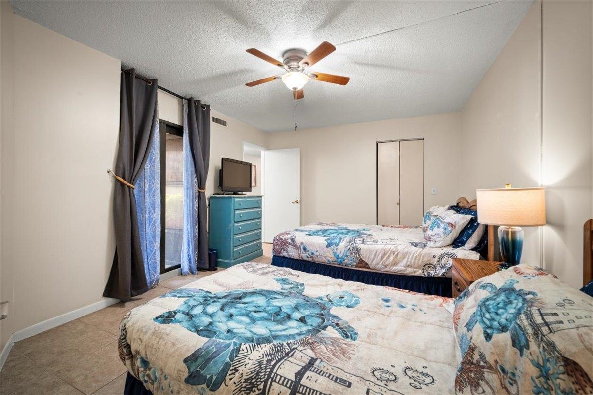 2 Dondanville Road, Unit 115 St. Augustine, FL 32080 - Photo 11 of 36 a bedroom with a bed chandelier and a window
