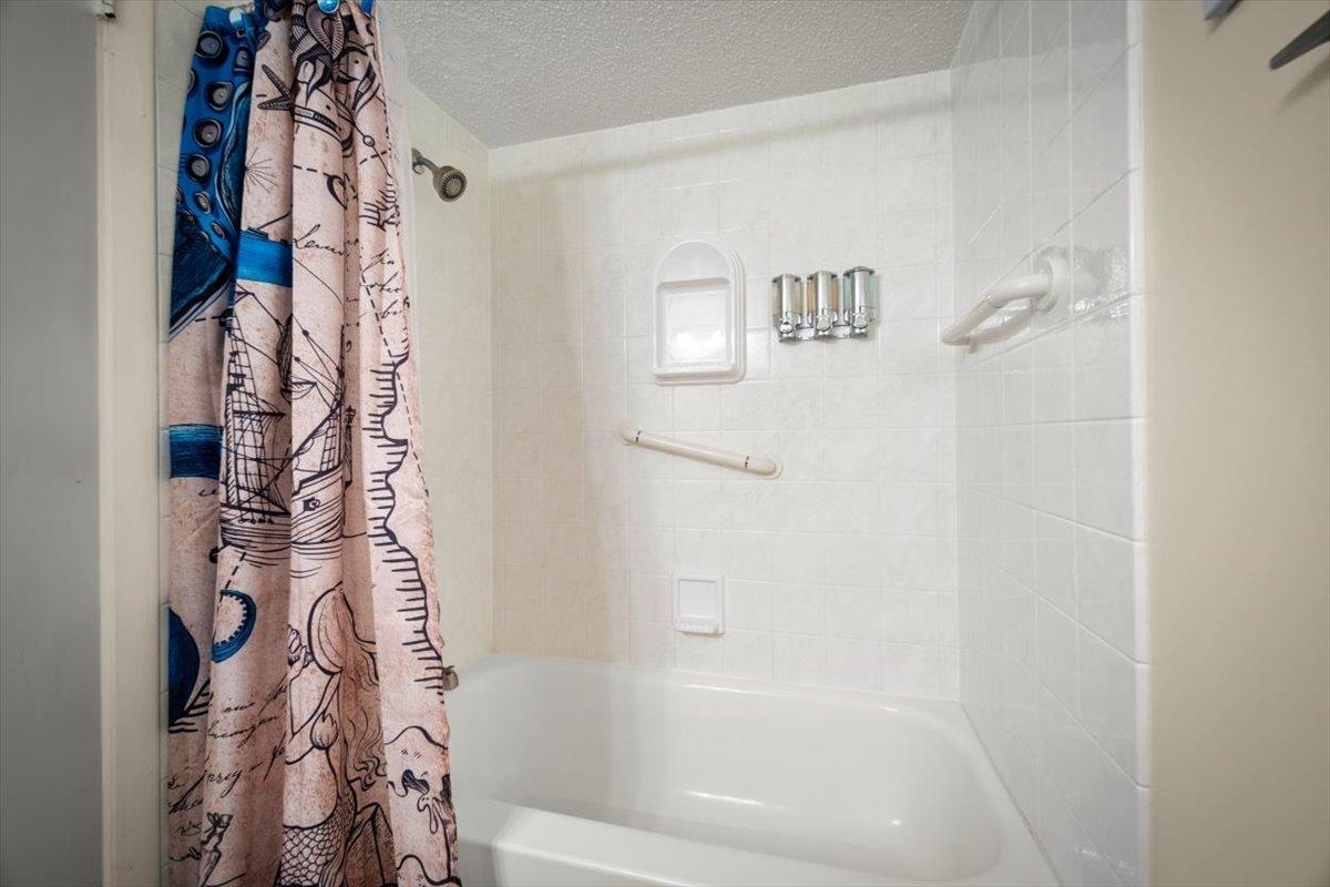 2 Dondanville Road, Unit 115 St. Augustine, FL 32080 - Photo 13 of 36 a bathroom with a bathtub and shower