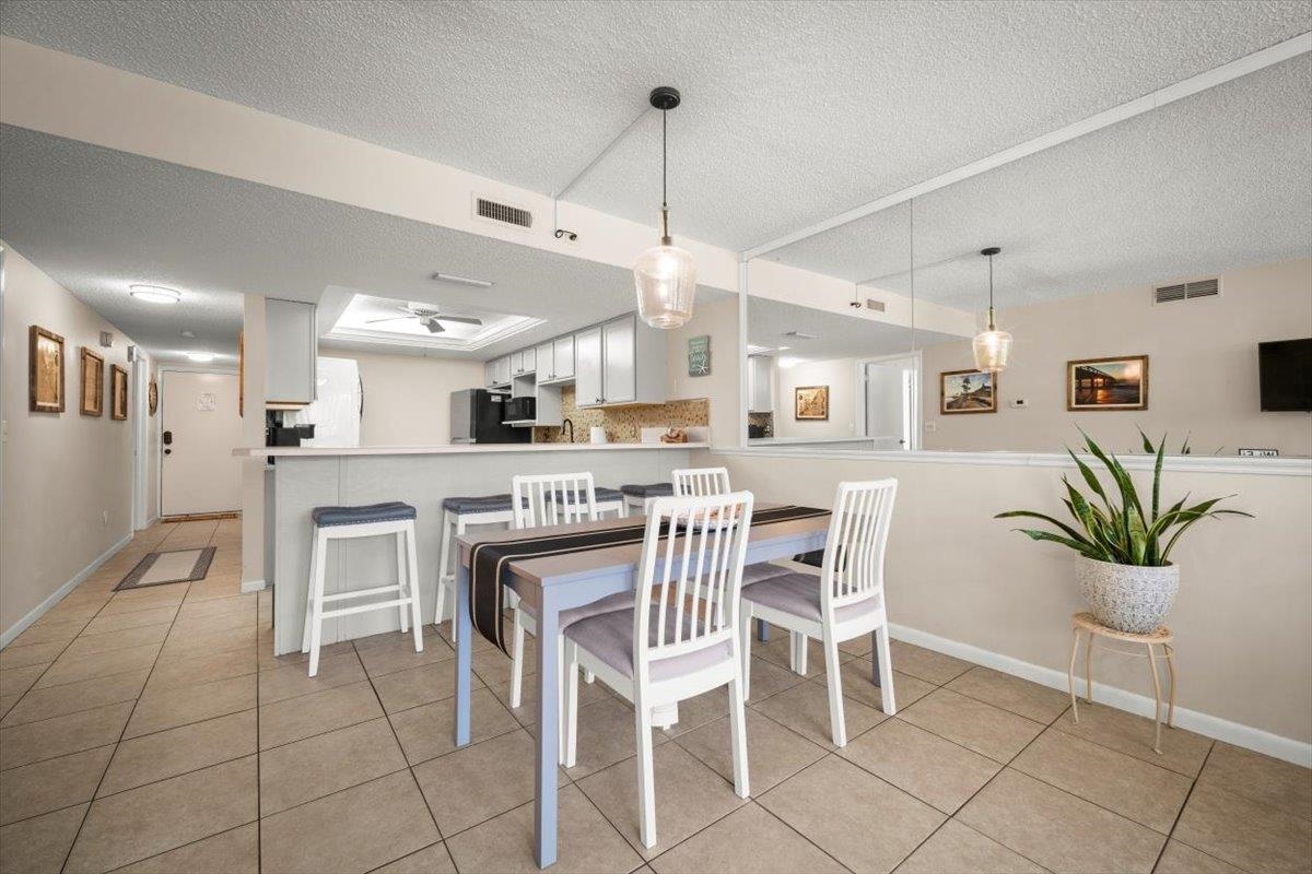 2 Dondanville Road, Unit 115 St. Augustine, FL 32080 - Photo 5 of 36 a kitchen with stainless steel appliances a table and chairs in it