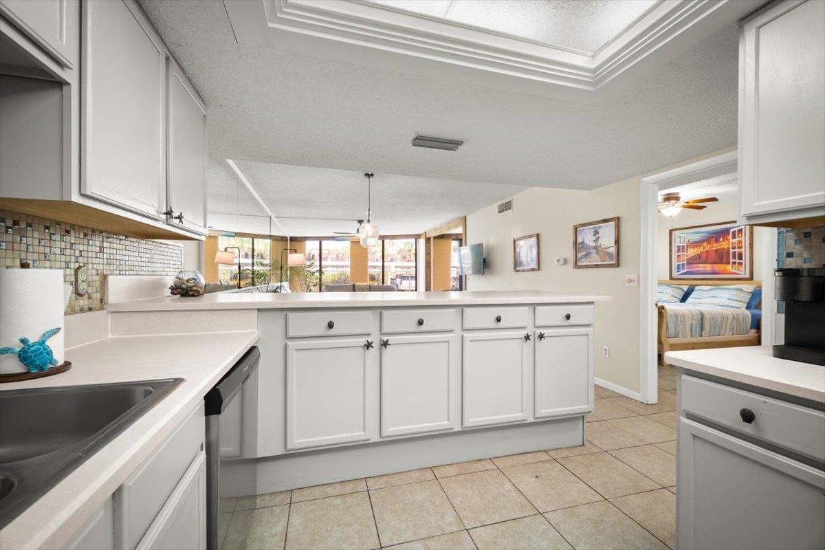 2 Dondanville Road, Unit 115 St. Augustine, FL 32080 - Photo 6 of 36 a kitchen with white cabinets and appliances