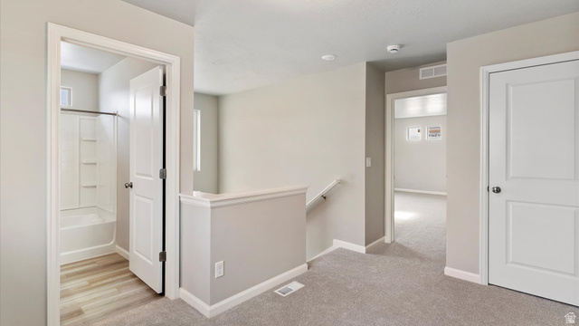 82 Provo River Road, Unit 251 Saratoga Springs, UT 84045 - Photo 14 of 32 Upper level landing featuring light gray carpeting, neutral wall paint, and white trim