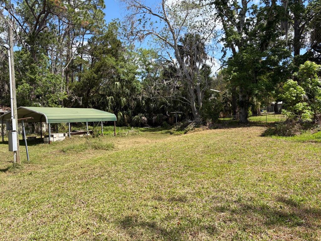 38 65th Street Yankeetown, FL 34498 - Photo 4 of 15 a view of a swimming pool with lawn chairs under an umbrella