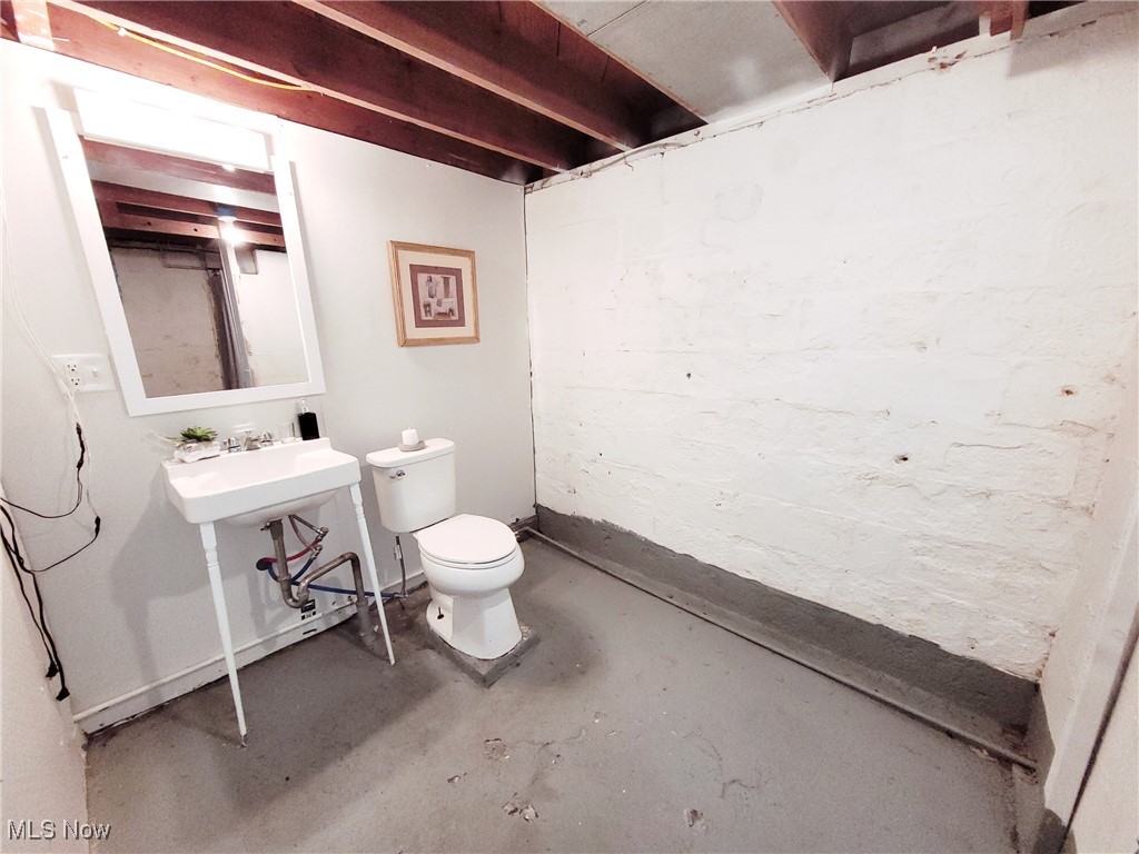 3524 State Road Ashtabula, OH 44004 - Photo 29 of 45 Full bathroom featuring toilet, concrete flooring, and a sink