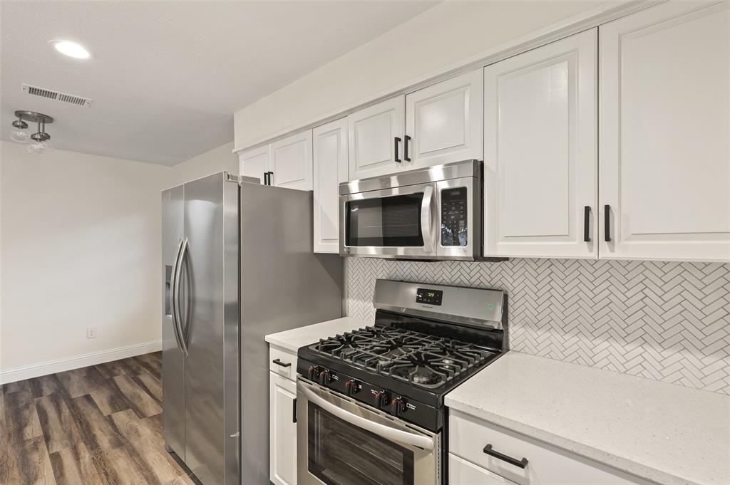 3126 Jubilee Trail Dallas, TX 75229 - Photo 8 of 38 a kitchen with stainless steel appliances a refrigerator sink and microwave