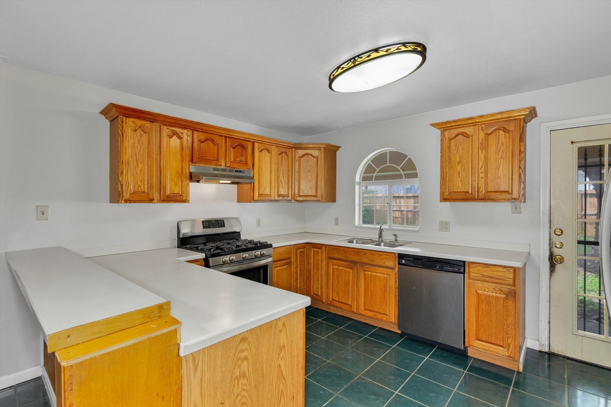 406 Red Ripple Road Houston, TX 77091 - Photo 11 of 37 a kitchen with a sink a stove and cabinets
