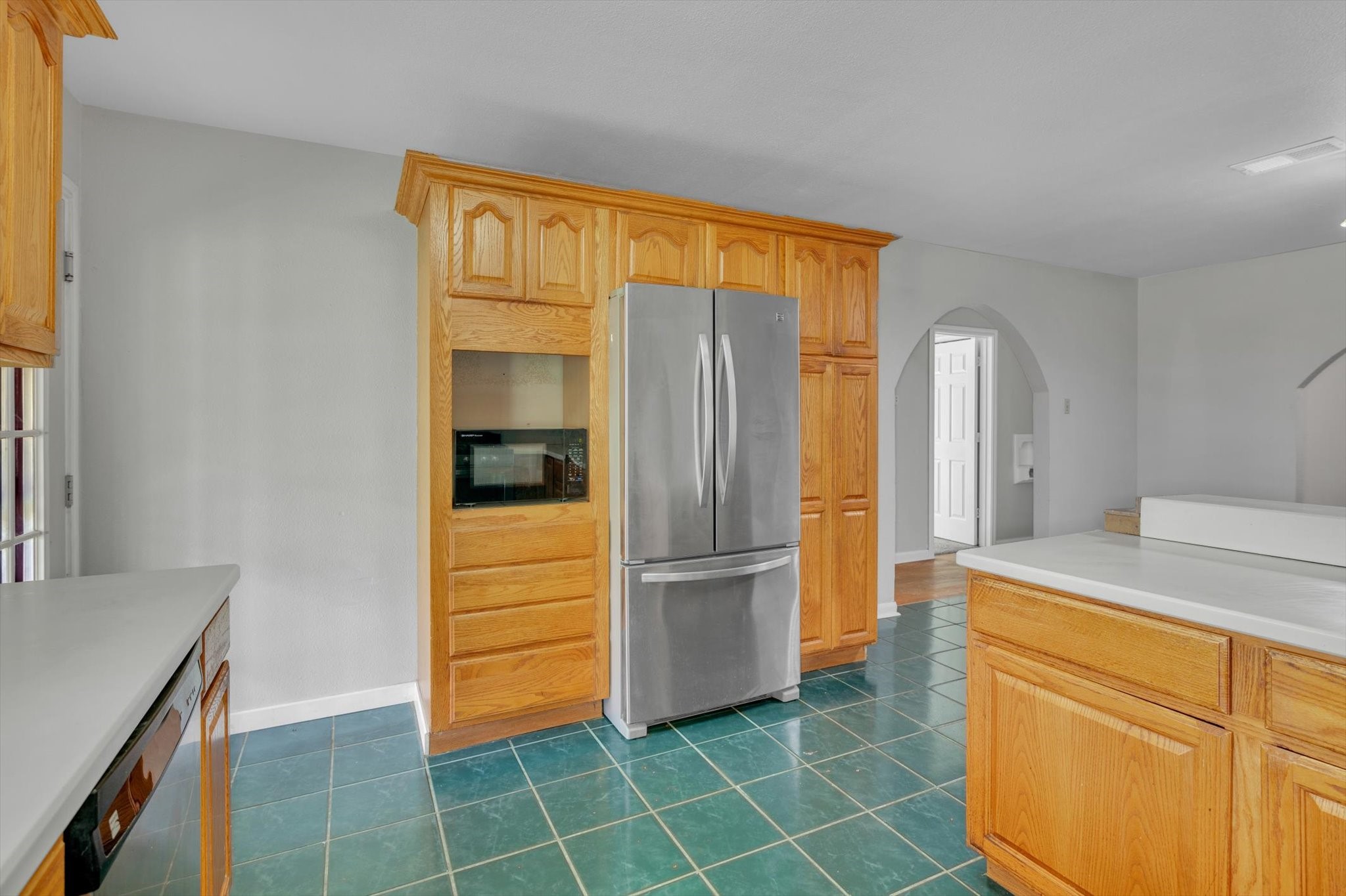 406 Red Ripple Road Houston, TX 77091 - Photo 14 of 37 a kitchen with a refrigerator and cabinets
