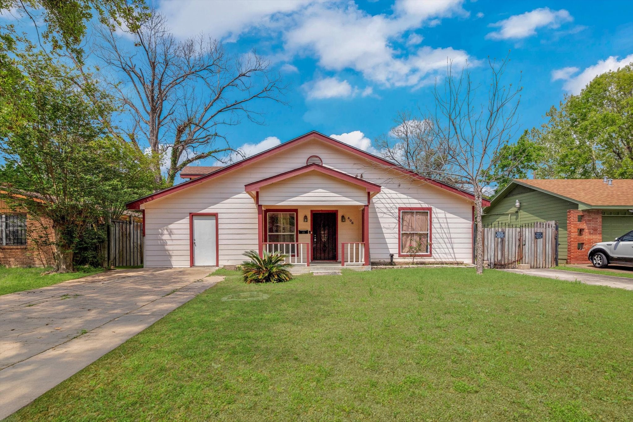 406 Red Ripple Road Houston, TX 77091 - Photo 2 of 37 a front view of a house with a yard and trees