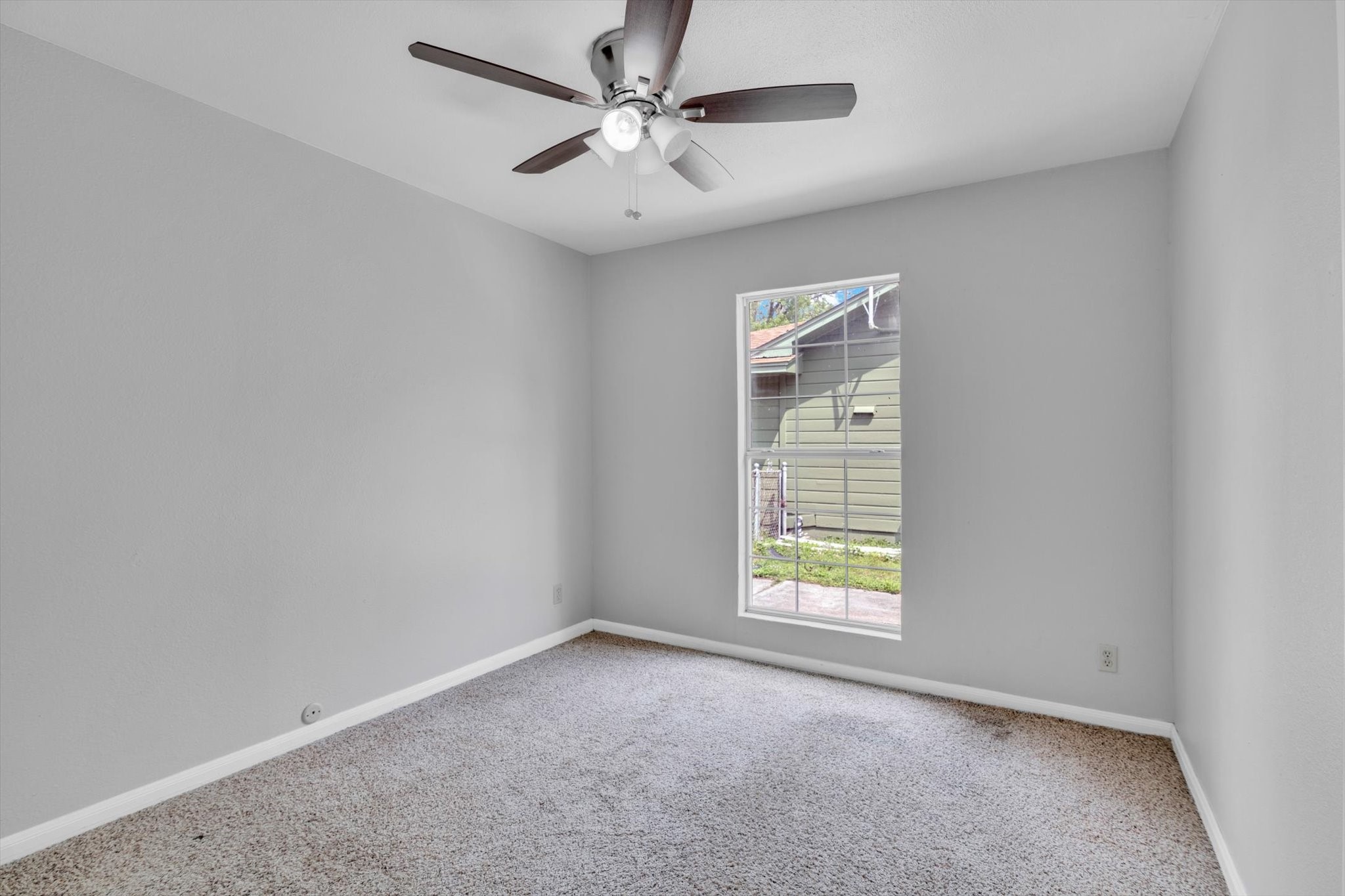 406 Red Ripple Road Houston, TX 77091 - Photo 23 of 37 an empty room with windows and fan