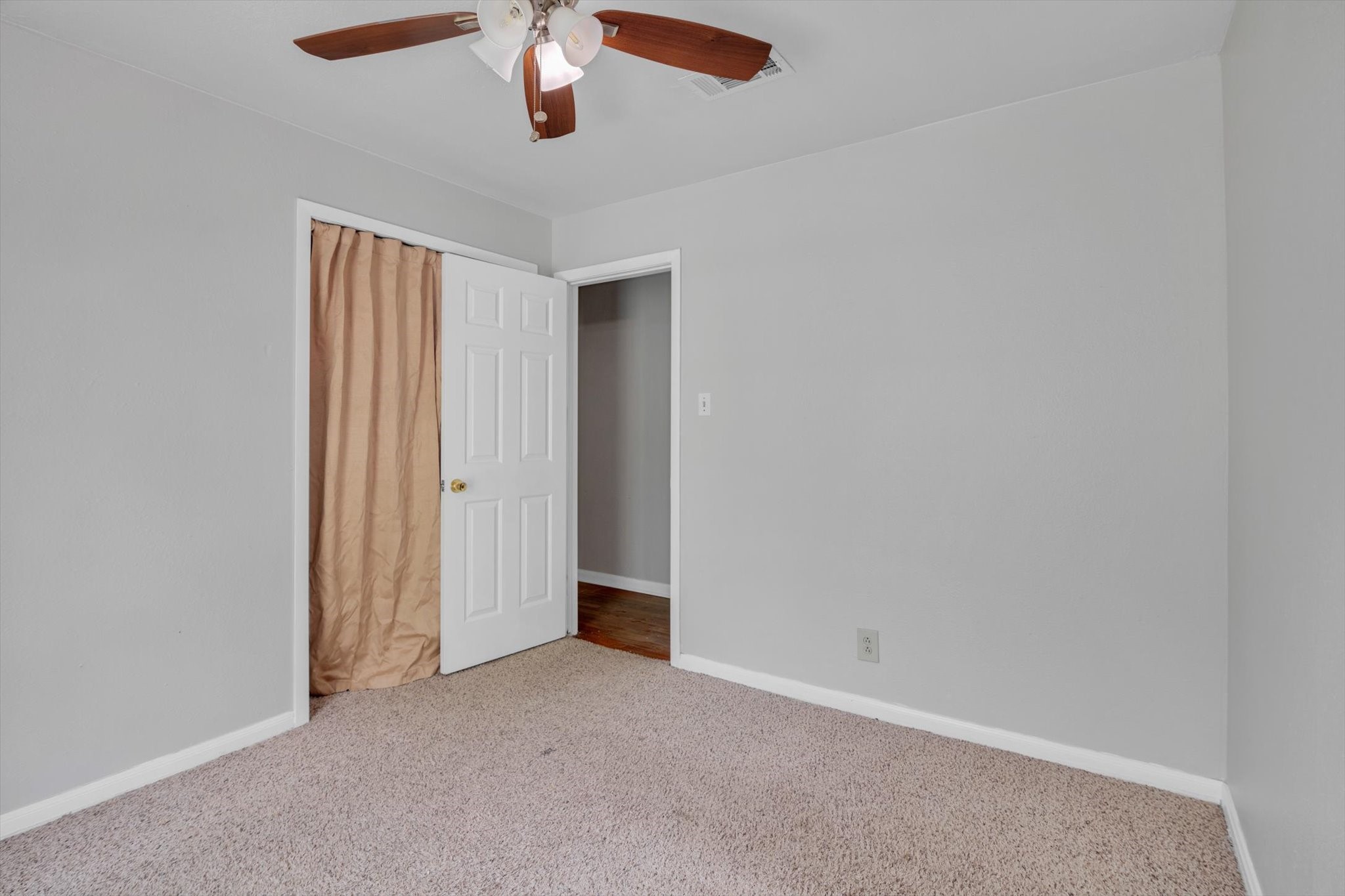 406 Red Ripple Road Houston, TX 77091 - Photo 24 of 37 an empty room with a chandelier fan