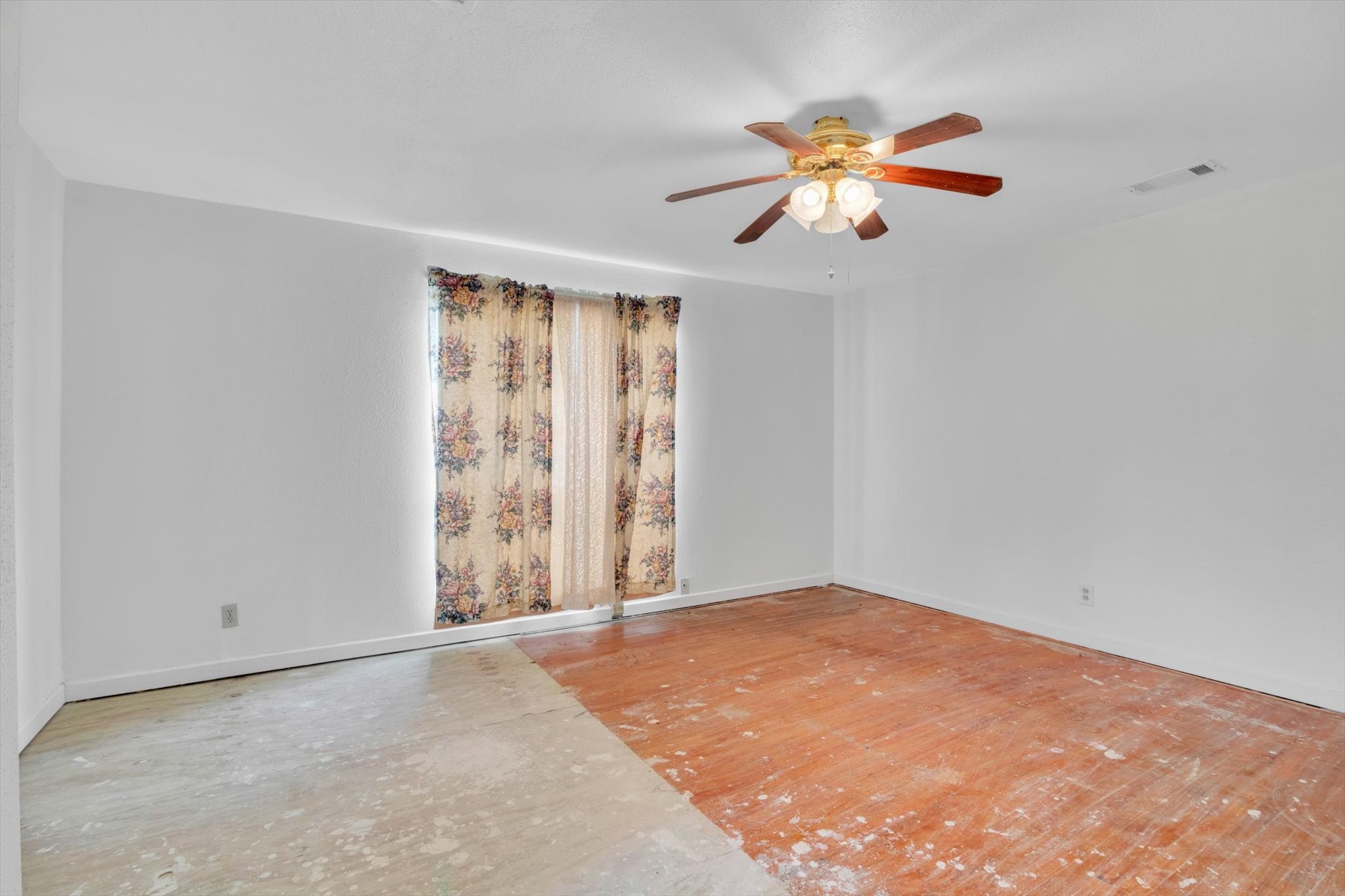 406 Red Ripple Road Houston, TX 77091 - Photo 27 of 37 wooden floor in an empty room with a window