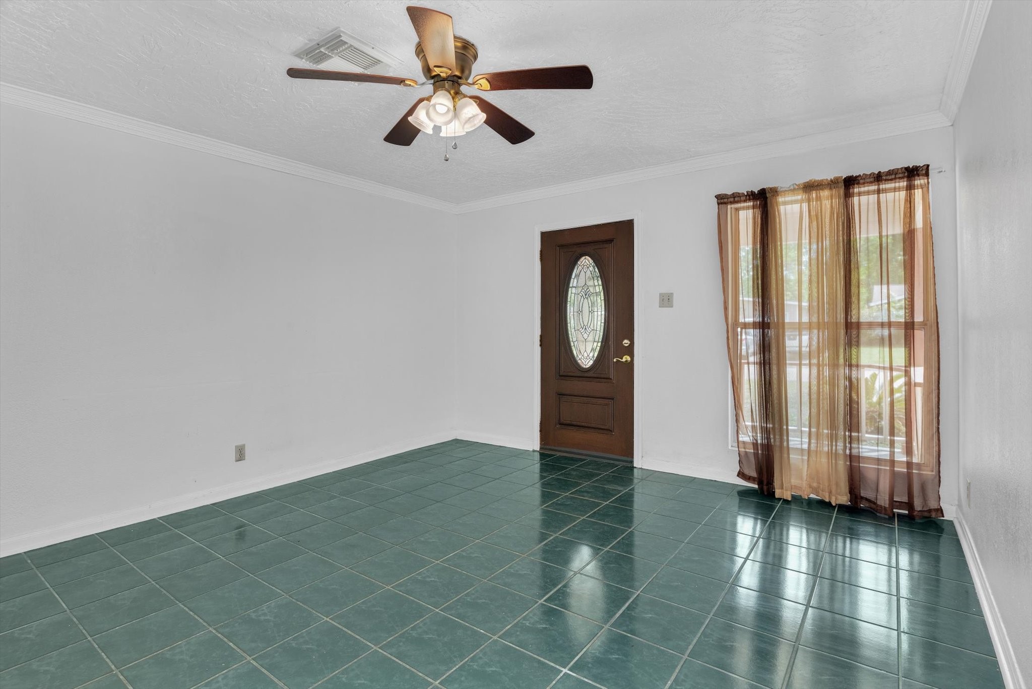 406 Red Ripple Road Houston, TX 77091 - Photo 5 of 37 an empty room with wooden floor fan and windows