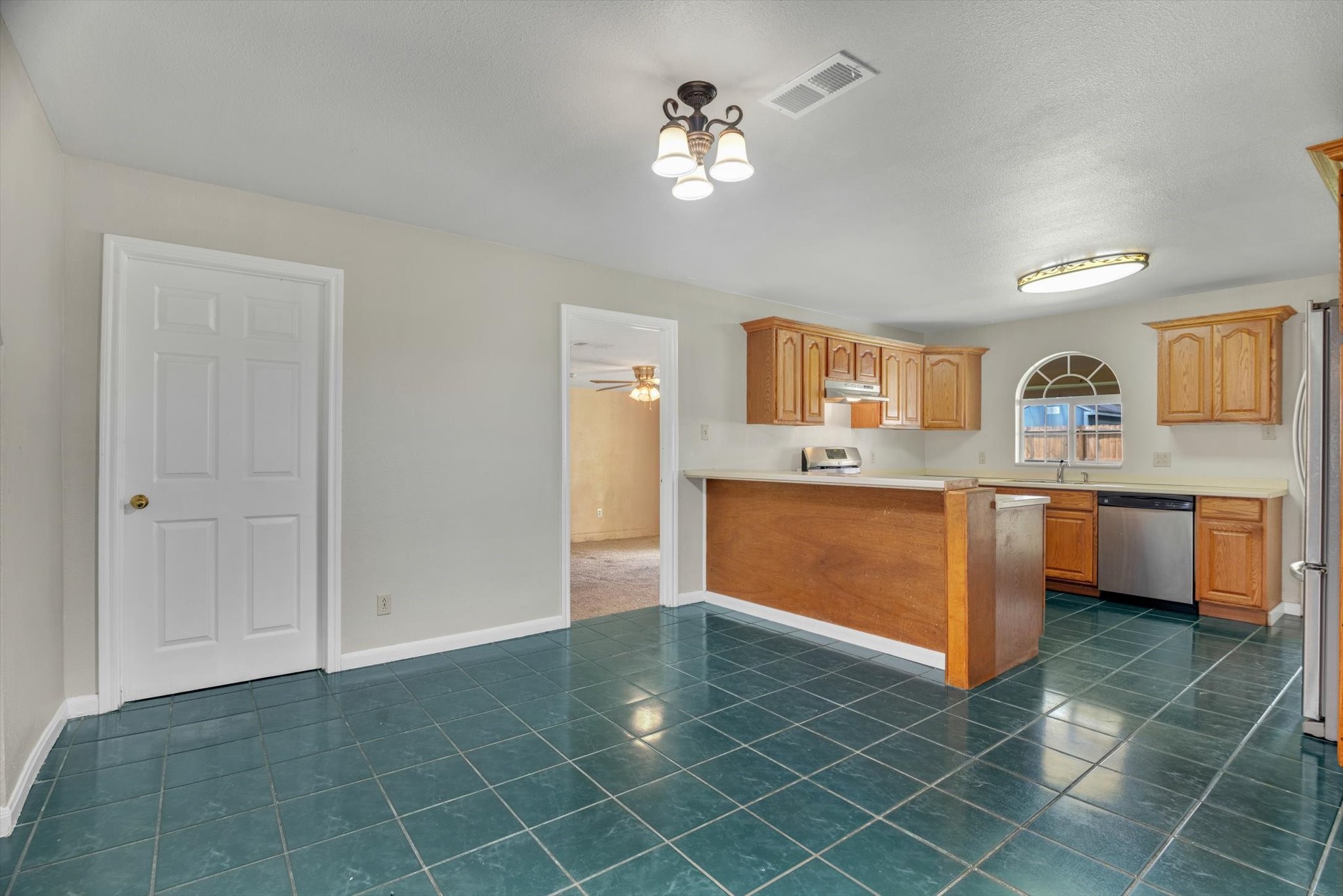 406 Red Ripple Road Houston, TX 77091 - Photo 8 of 37 a view of a kitchen with a sink cabinets and a window