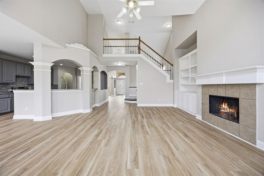 1904 Meera Lane Mansfield, TX 76063 - Photo 12 of 35 a view of a livingroom with wooden floor and a fireplace