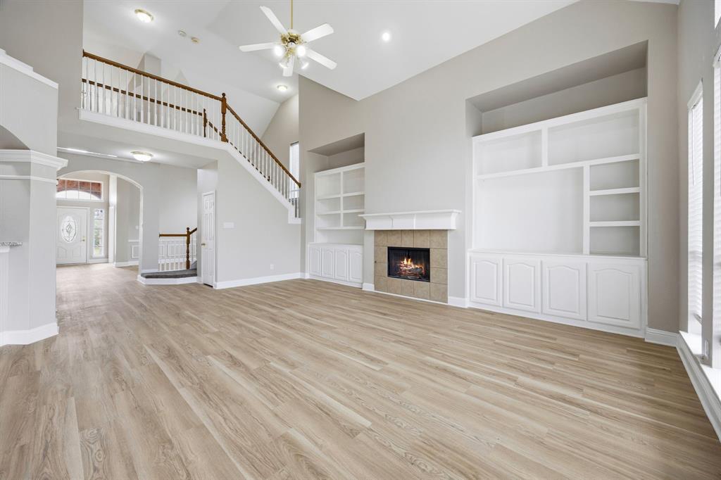 1904 Meera Lane Mansfield, TX 76063 - Photo 13 of 35 a view of empty room with wooden floor and fireplace