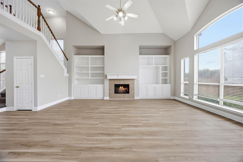 1904 Meera Lane Mansfield, TX 76063 - Photo 14 of 35 a view of an empty room with wooden floor and a window