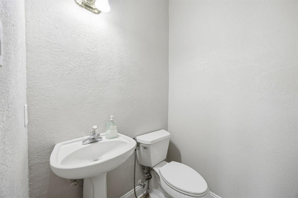 1904 Meera Lane Mansfield, TX 76063 - Photo 20 of 35 a bathroom with a sink a toilet and mirror