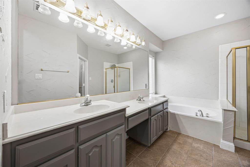 1904 Meera Lane Mansfield, TX 76063 - Photo 24 of 35 a spacious bathroom with a bathtub shower sink double and mirror