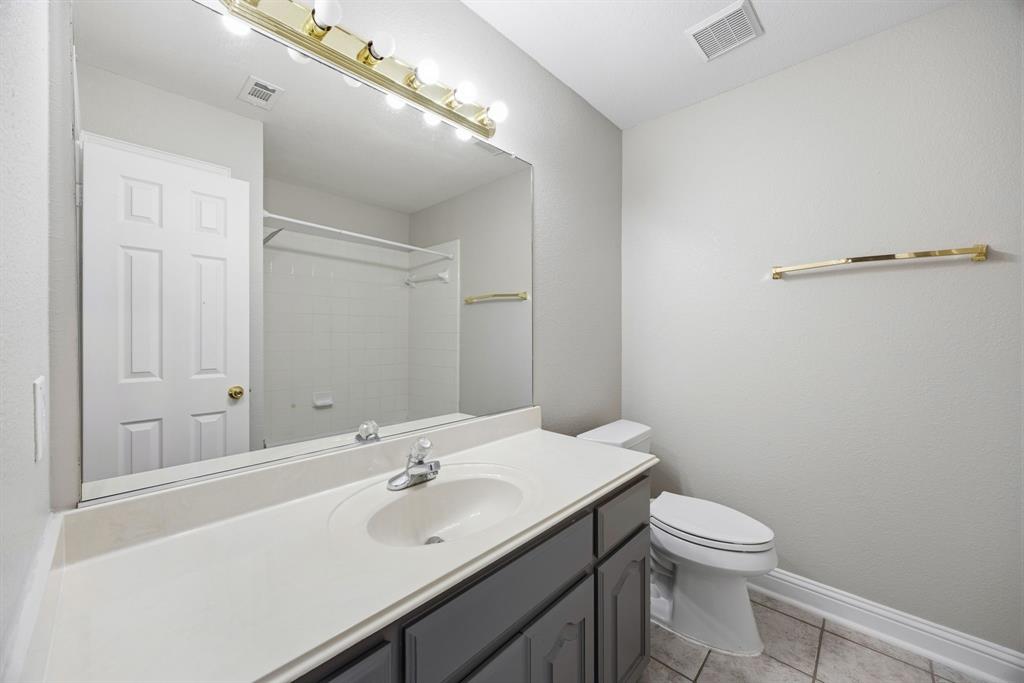 1904 Meera Lane Mansfield, TX 76063 - Photo 28 of 35 a bathroom with a sink mirror and toilet