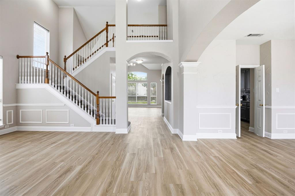 1904 Meera Lane Mansfield, TX 76063 - Photo 3 of 35 a view of a hallway view with wooden floor and staircase