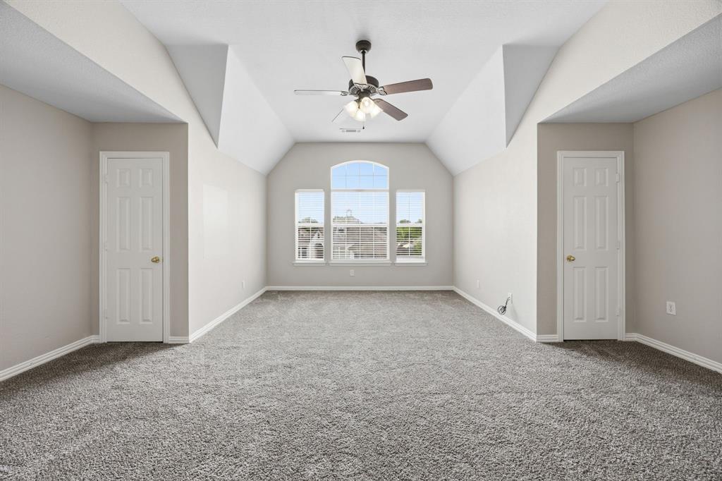 1904 Meera Lane Mansfield, TX 76063 - Photo 32 of 35 an empty room that has a window and a ceiling fan