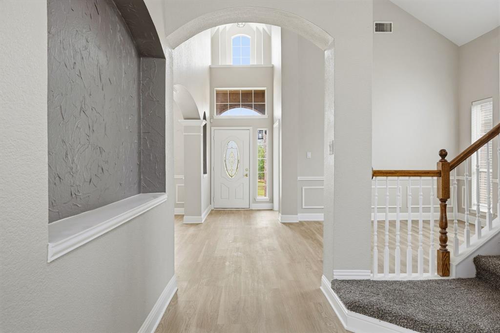 1904 Meera Lane Mansfield, TX 76063 - Photo 4 of 35 a view of a hallway with wooden floor and staircase