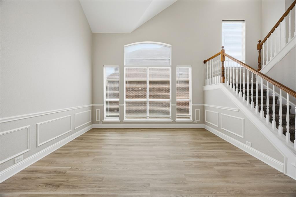 1904 Meera Lane Mansfield, TX 76063 - Photo 6 of 35 a view of an empty room with wooden floor and a window