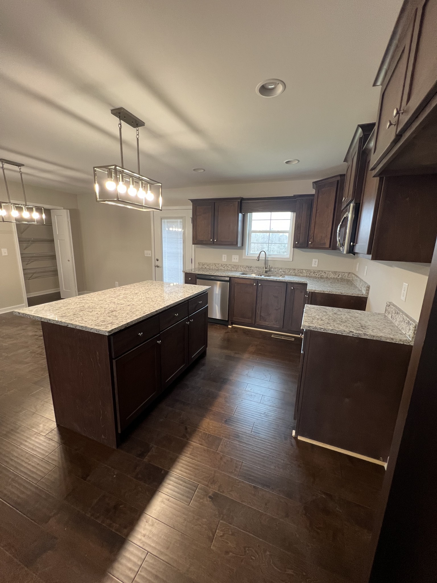 1669 New Deal Potts Road Portland, TN 37148 - Photo 3 of 17 a living room with stainless steel appliances kitchen island granite countertop furniture and a kitchen view