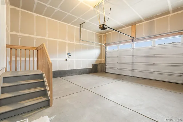 a view of an empty room with white walls and a window